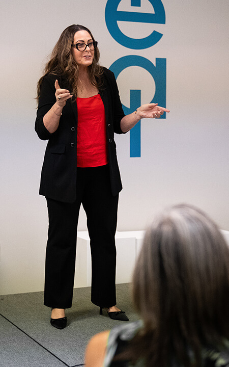 Josee Madison speaking to an audience about personal growth and mindful leadership