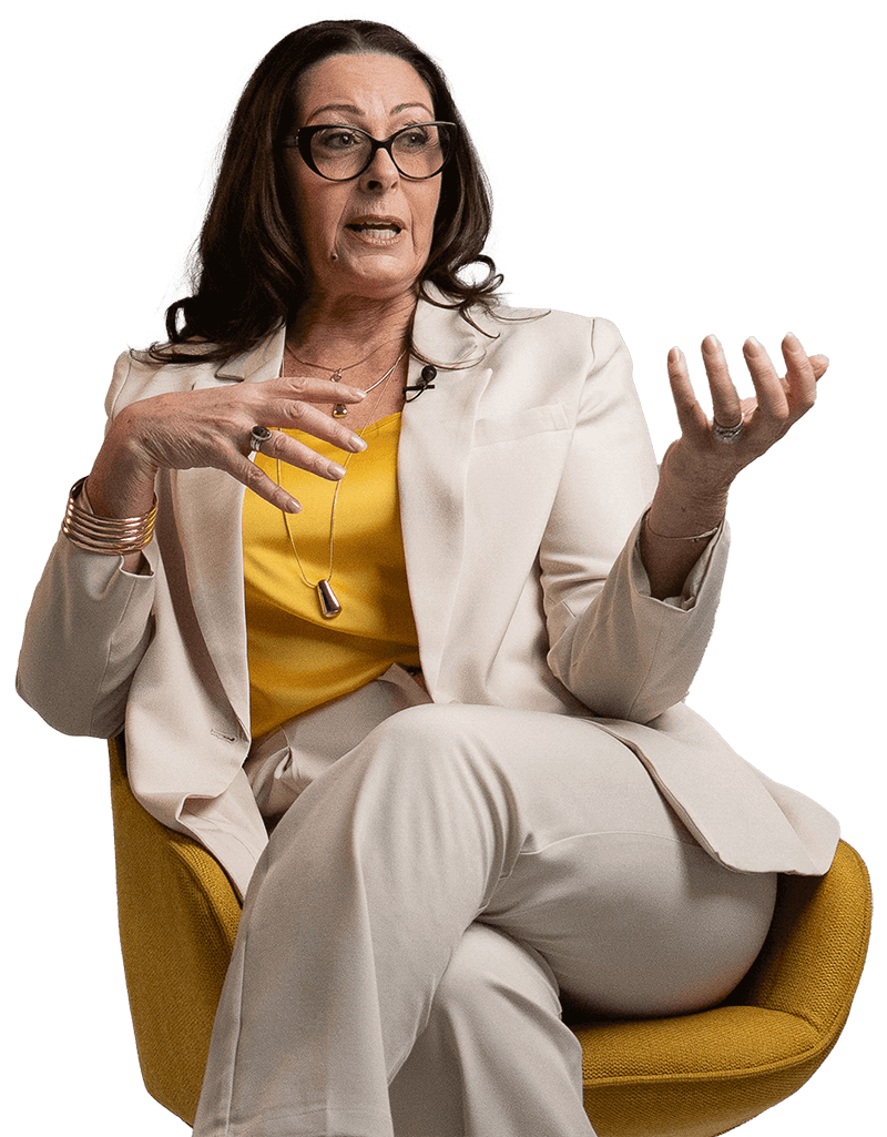 Josee Madison seated and speaking with open hand gestures, conveying clarity and intentional leadership