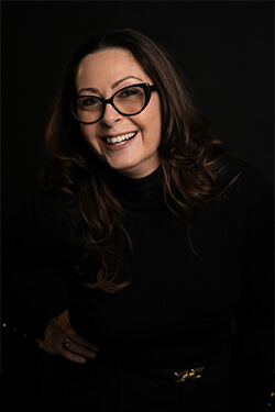 Josee Madison smiling in a professional portrait, representing mindful leadership and personal growth
