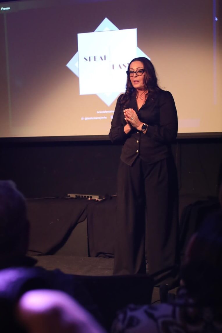 Josee Madison speaking to an audience about personal growth and mindful leadership